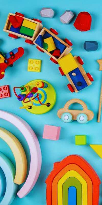 Various toys scattered over a baby blue background